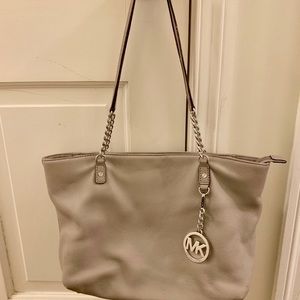 Michael Kors grey purse with attached pendant